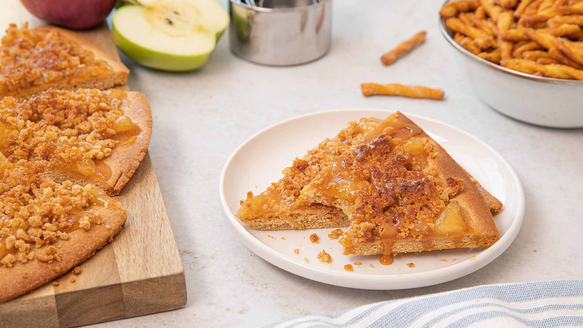 caramel apple dots pretzel crumble pizza plated and ready to serve