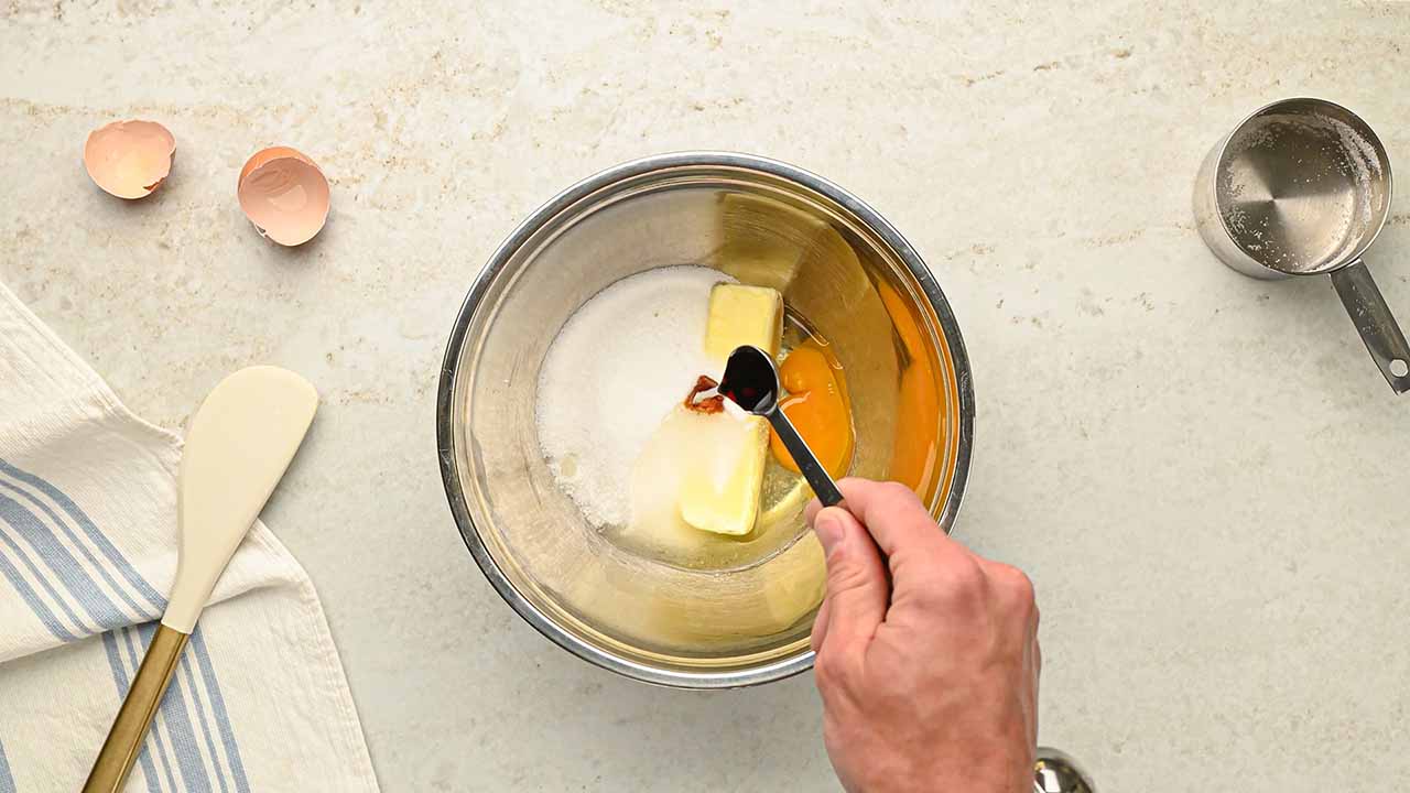 mixing butter, granulated sugar, and vanilla together in a large bowl