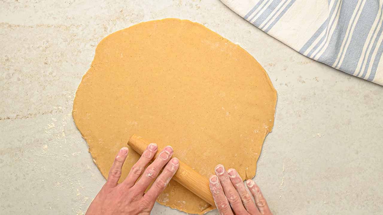 rolling out the dough into a circle or oval shape