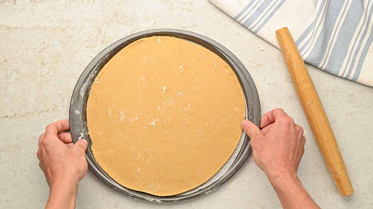 transferring the dough into a baking or pizza pan