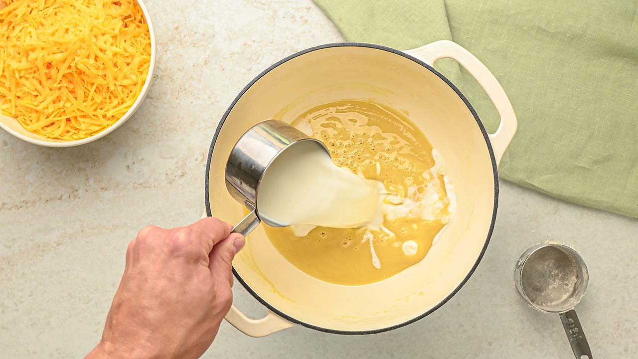 mixing milk into the large pot and stirring until reaching thickness