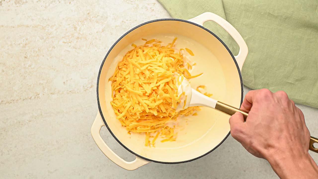 mixing cheddar cheese into the large pot until fully melted