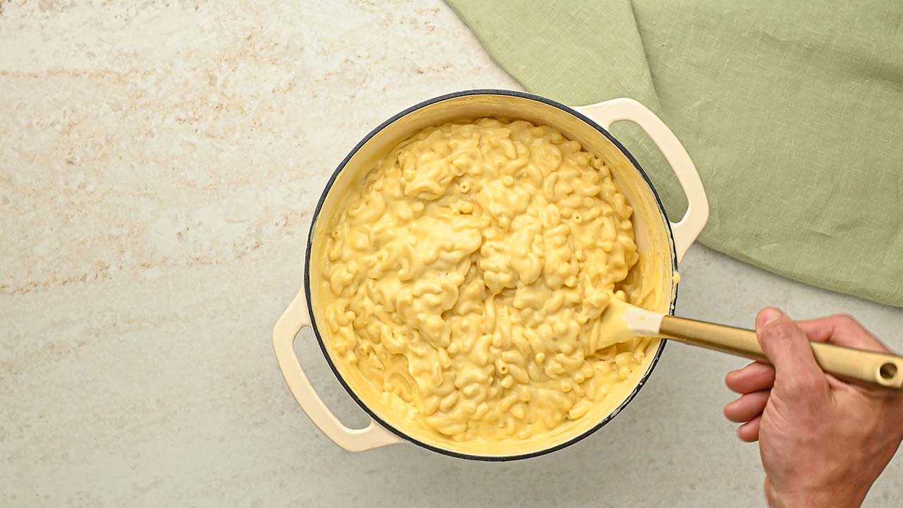 mixing together the macaroni and cheese mixture until well coated