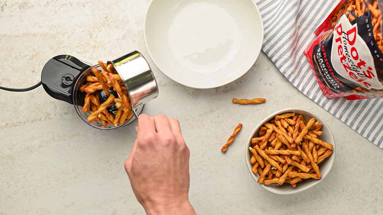 adding dots pretzels into the food processor