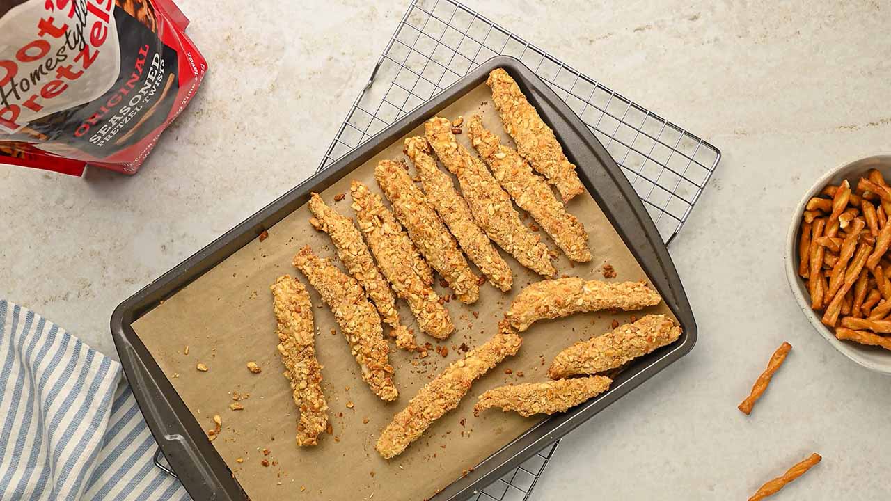 letting the fully cooked chicken strips cool on the baking sheet