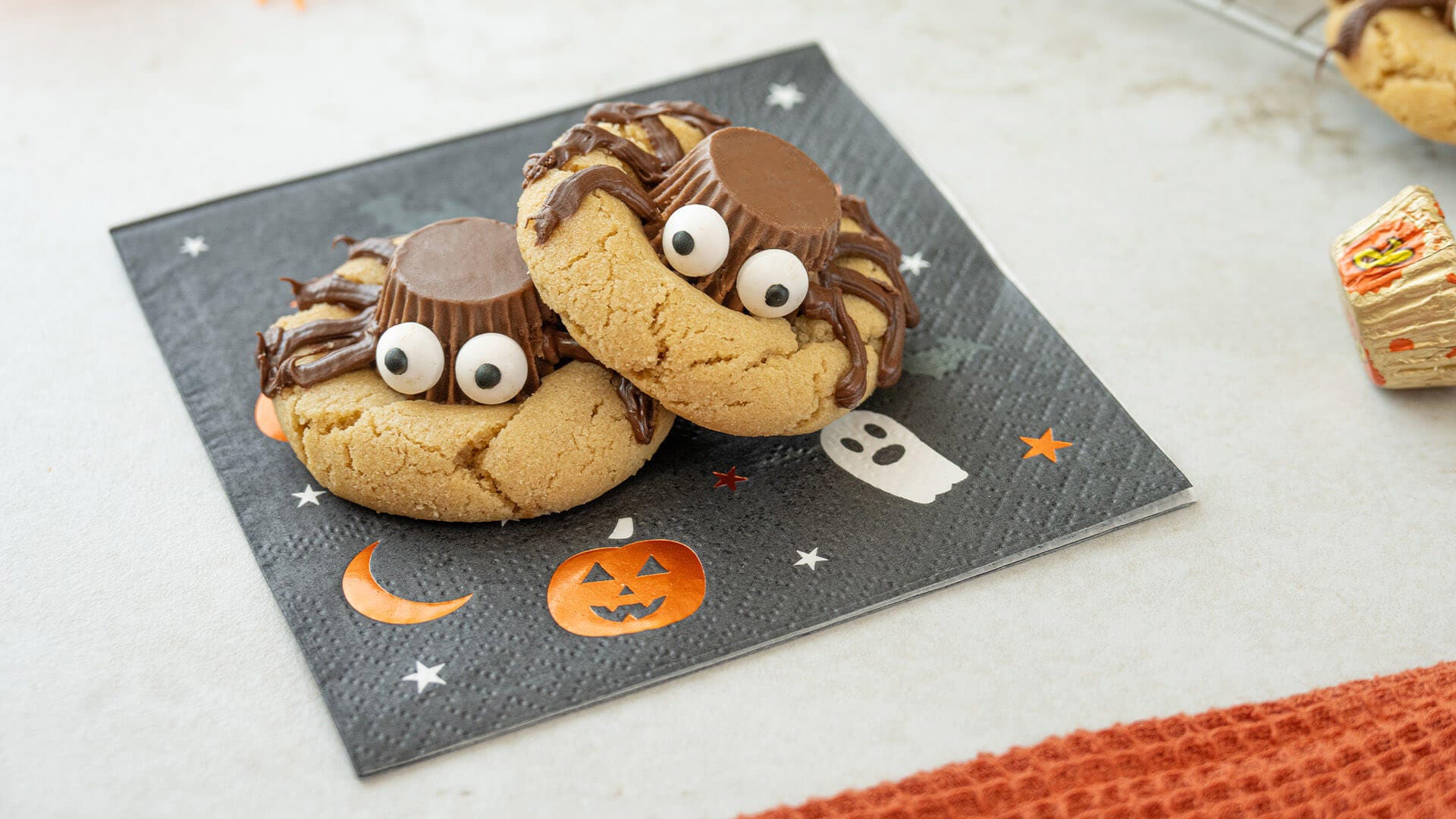 two reeses spider cookies on a napkin