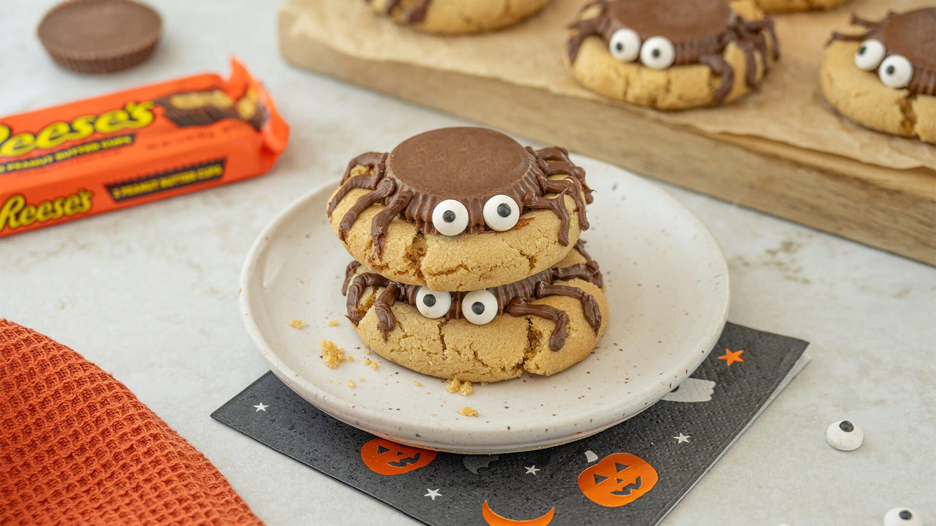 two reeses spider cookies stacked on top of eachother