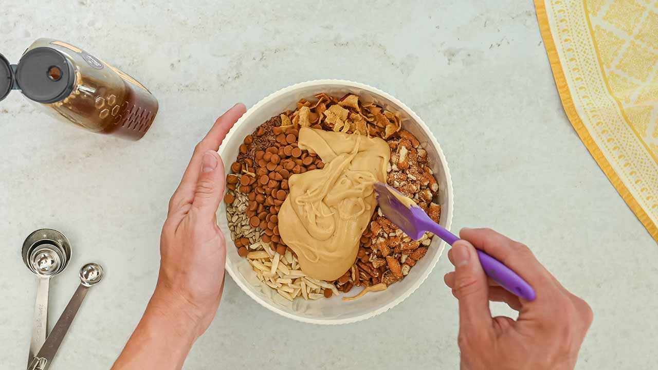 combining honey and nut mixtures together in a large bowl