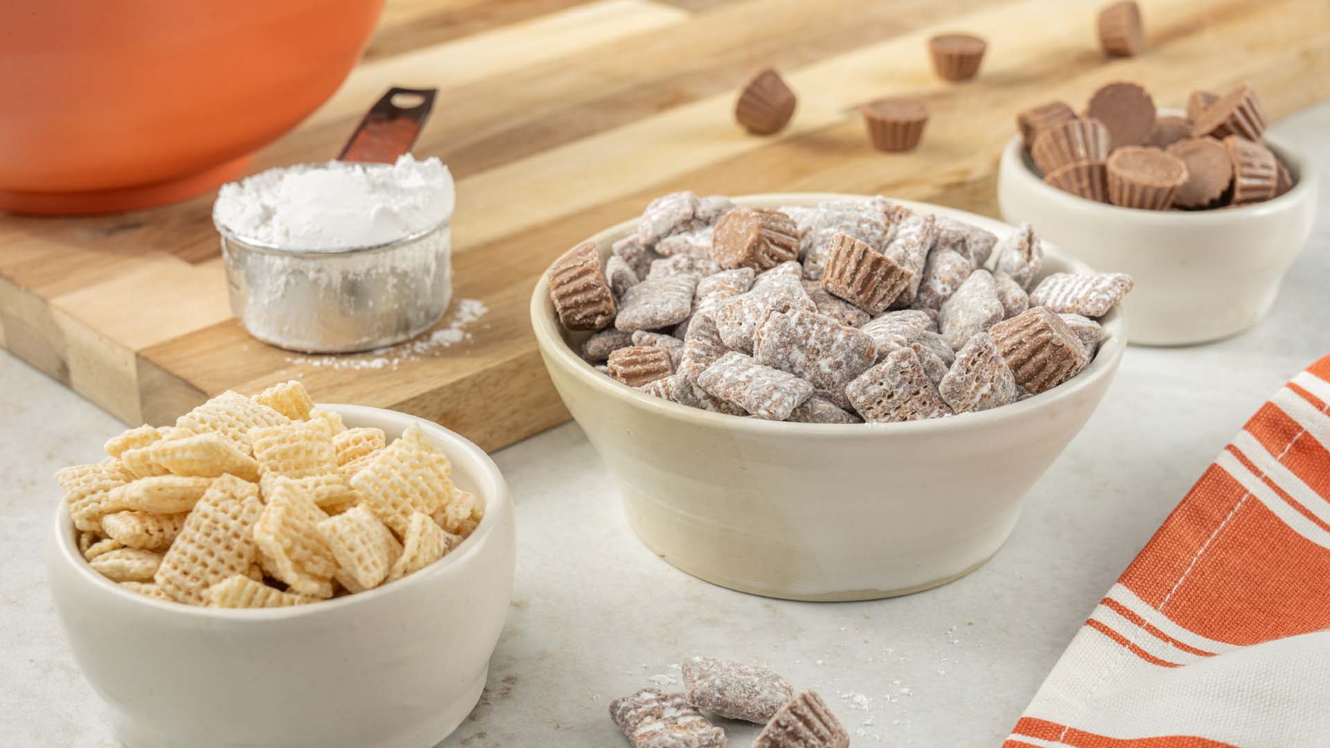 bowls of Puppy Chow and reeses miniatures
