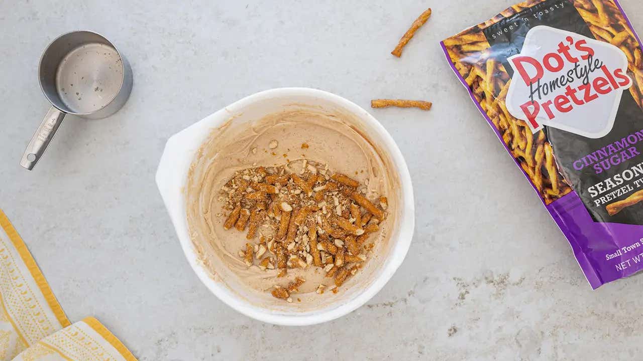 adding pretzel pieces into the bowl