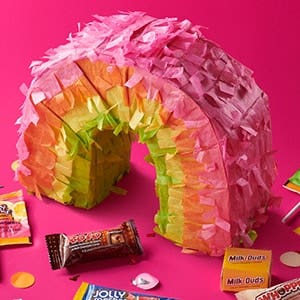 rainbow pinata surrounded by hersheys candies