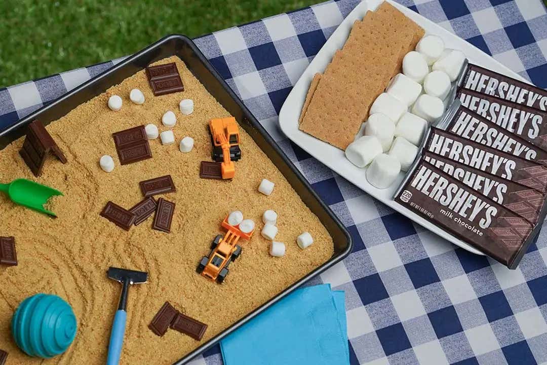 enjoying hersheys smores sensory bin outdoors