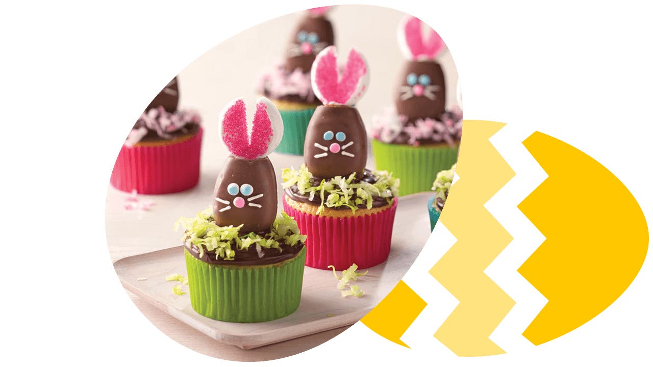 reeses eggs decorated as easter bunny cupcake toppers next to an easter egg design
