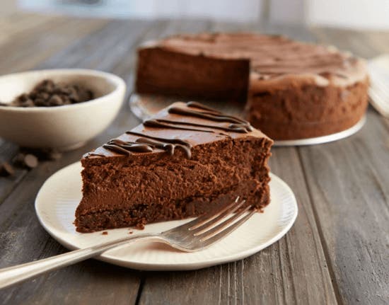 slice of hersheys special dark chocolate cheesecake on a white plate