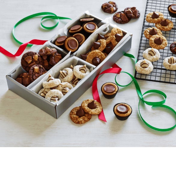 various cookies in a holiday themed cookie gift box