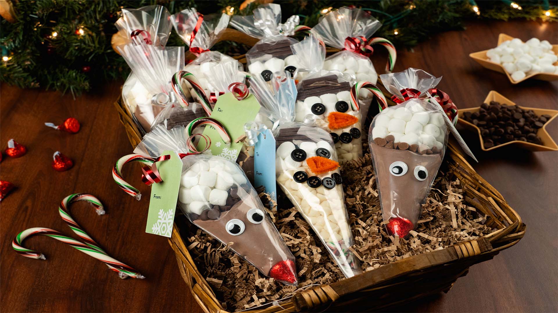holiday character themed piping bags filled with hot chocolate mix ingredients