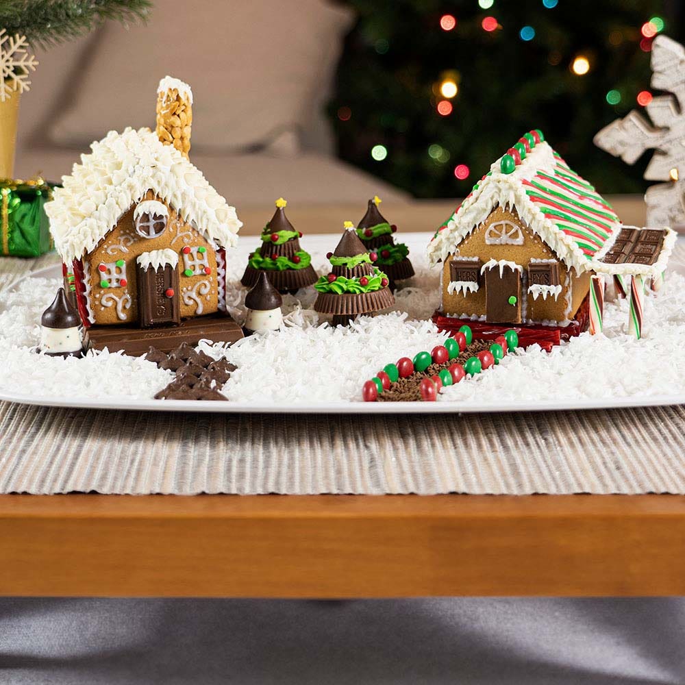 fully decorated gingerbread houses made with hersheys candy and white icing