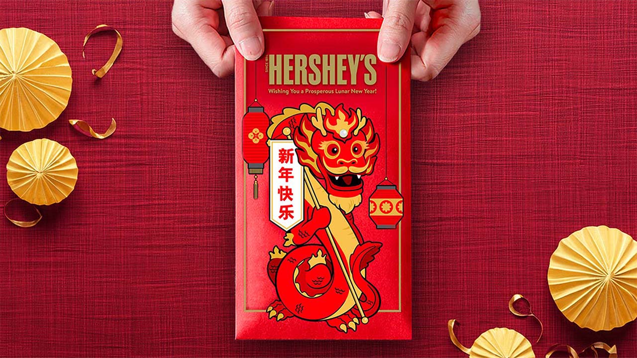 person holding a candy bar wrapped in a lunar new year candy bar wrapper
