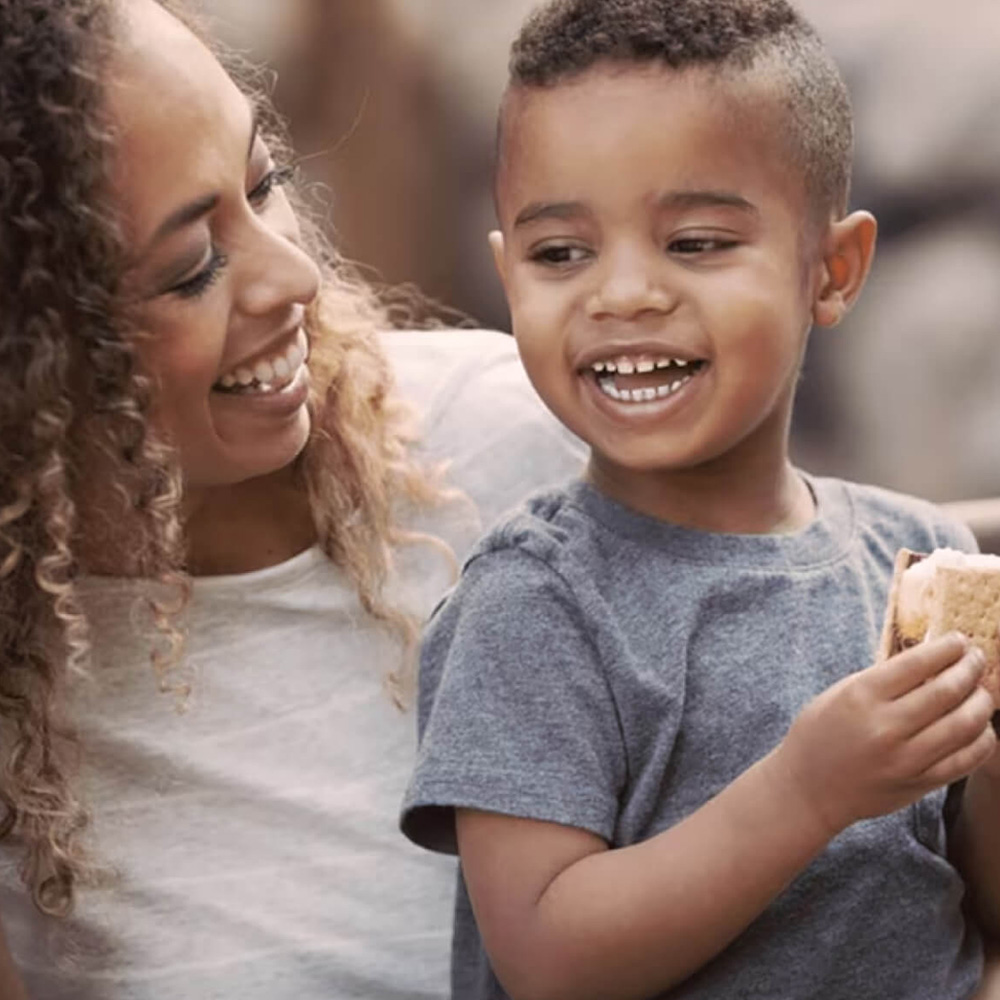 mother and son enjoying hersheys smores outdoors