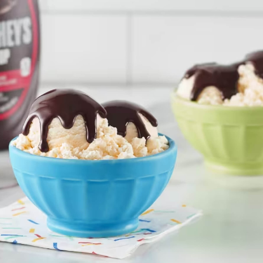 vanilla ice cream sundaes with hersheys chocolate syrup on top