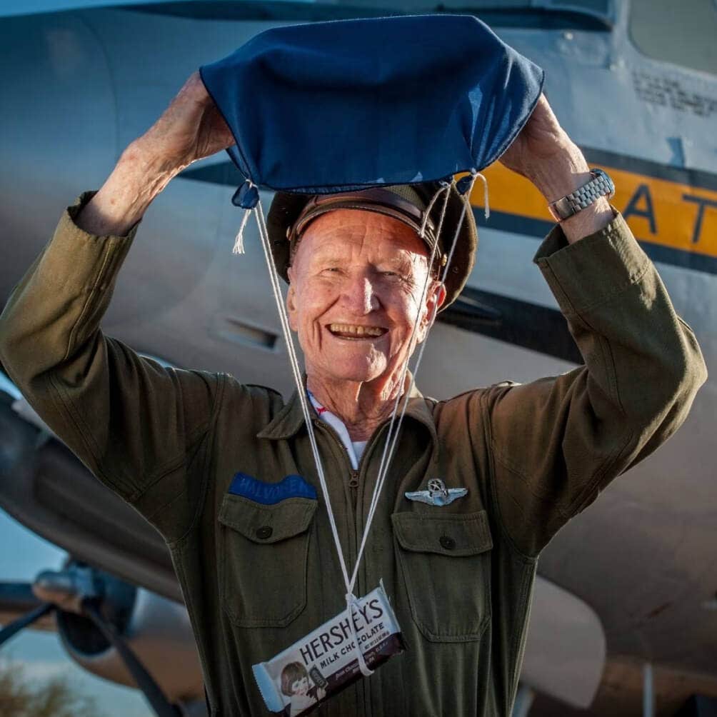 berlin candy bomber holding candy parachute while smiling