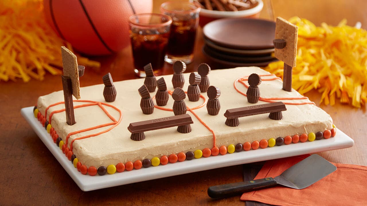 hersheys basketball court cake beside drinks and party decorations