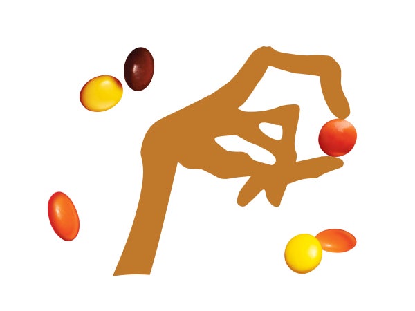 alien hand holding reeses pieces candy