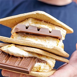 person holding a large stack of hersheys smores