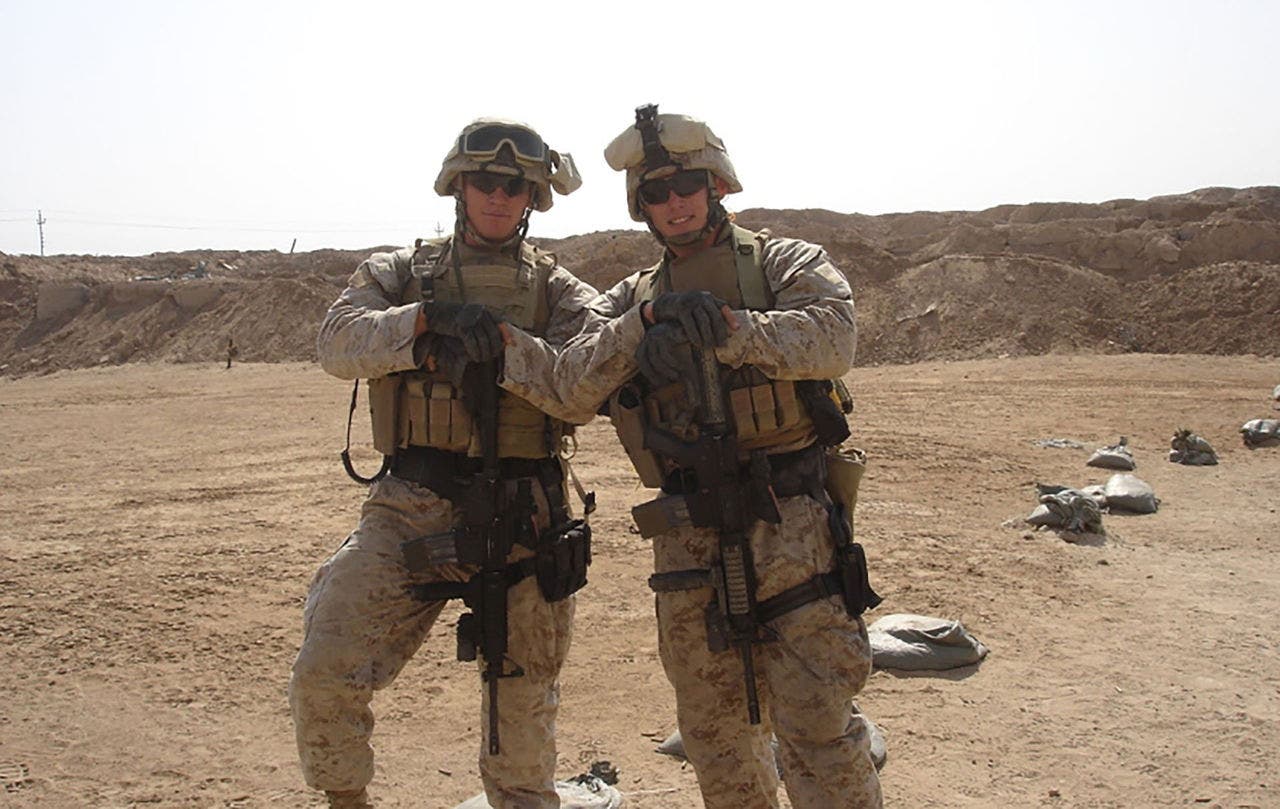 two marines posing in a desert