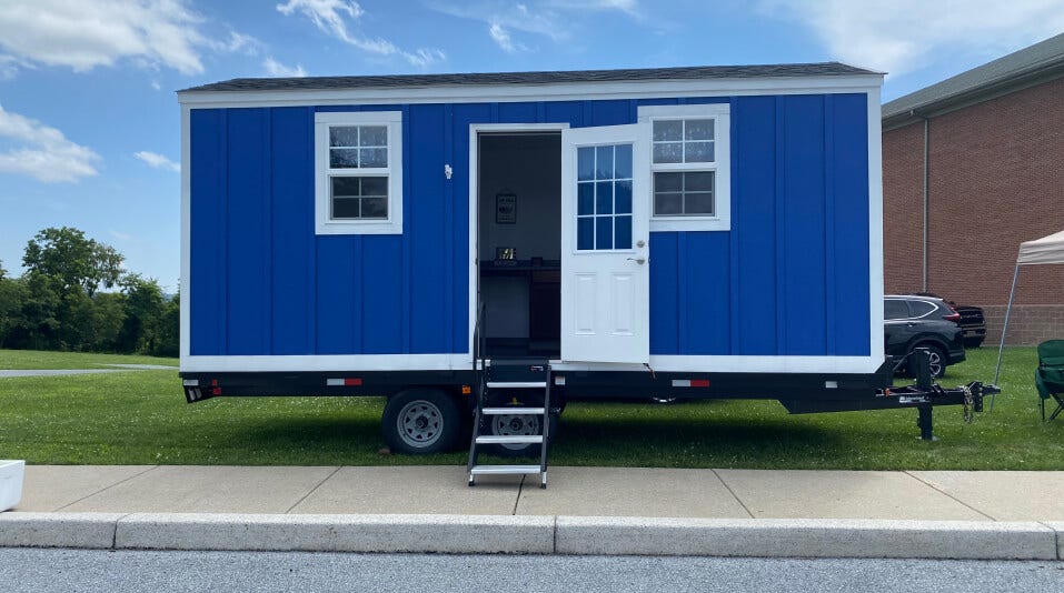 blue house on a truck trailer