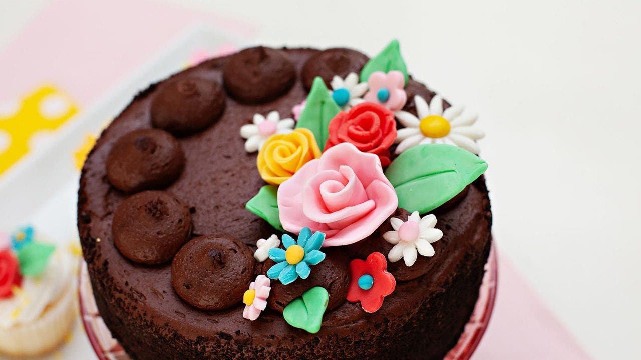 chocolate cake topped with fondant spring flowers