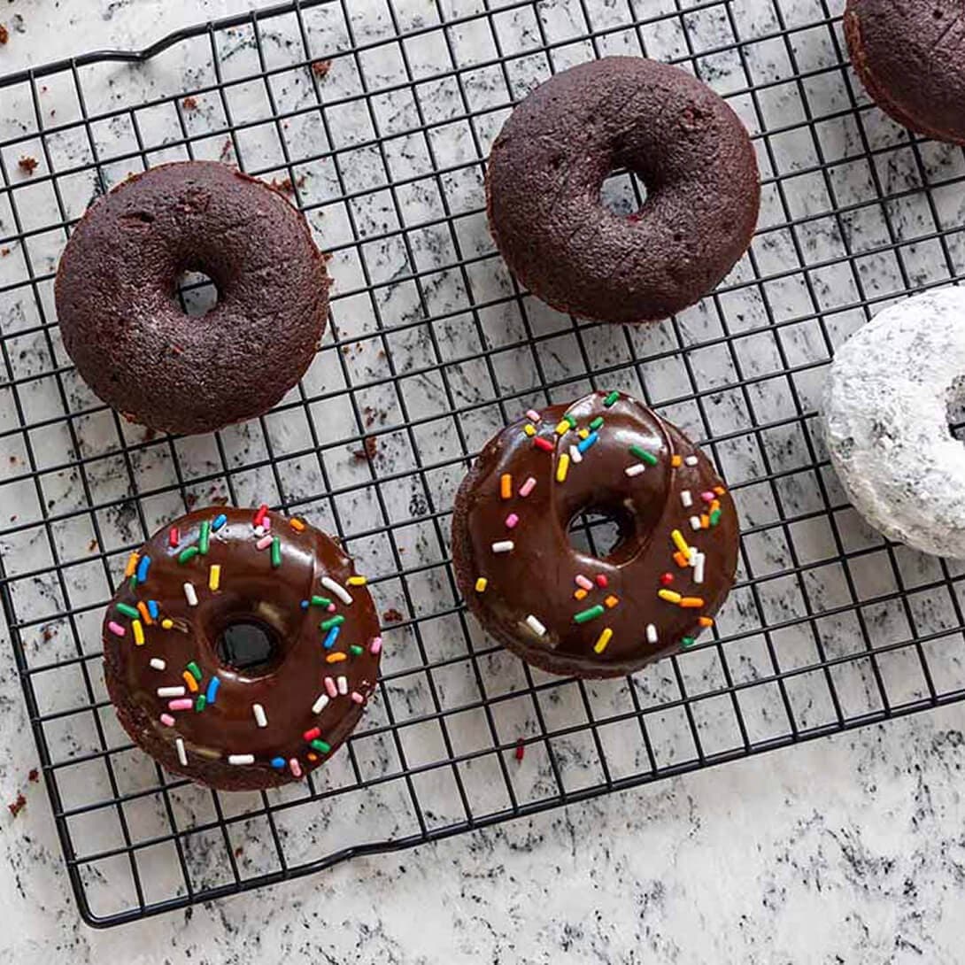 donuts resting on a cooling rack