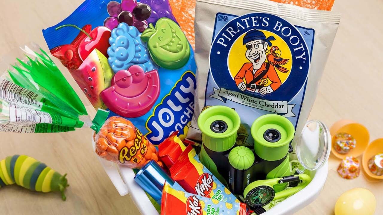 outdoor themed basket filled with hersheys candies, snacks, and outdoor accessories