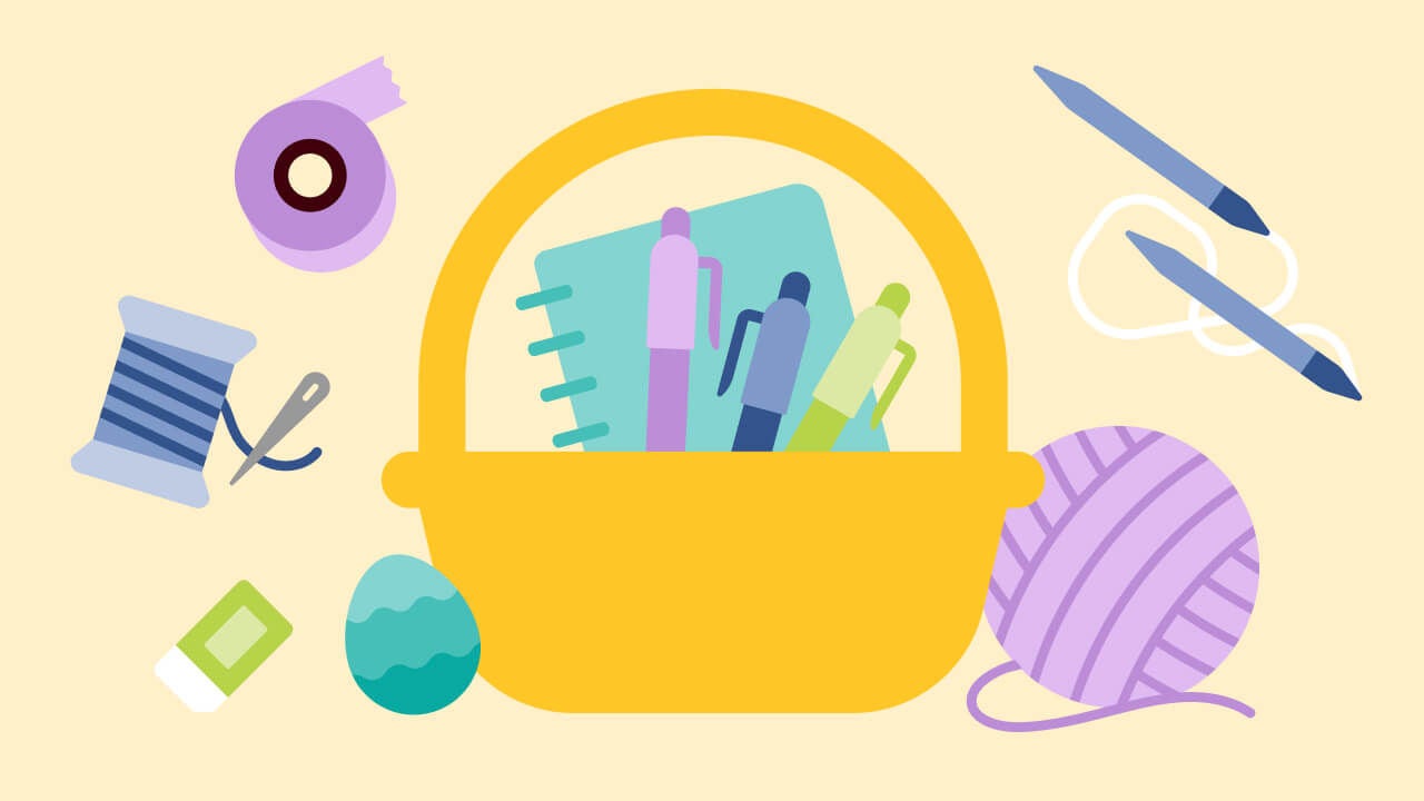 basket filled with art supplies, stationary, and assorted hersheys candy