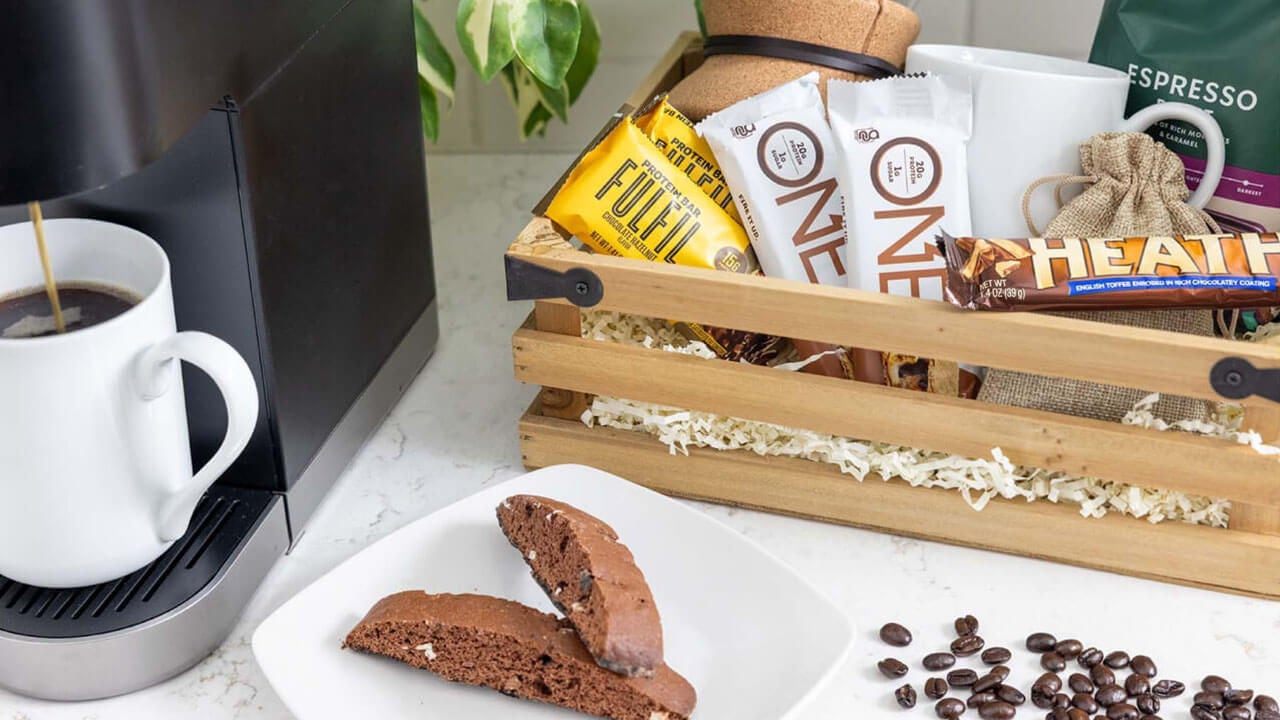 basket filled with coffee grounds, tea bags, and assorted hersheys candy and protein bars