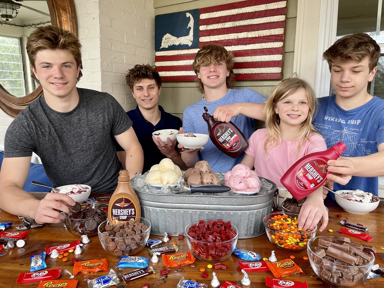 kids smiling in front of the sundae bar