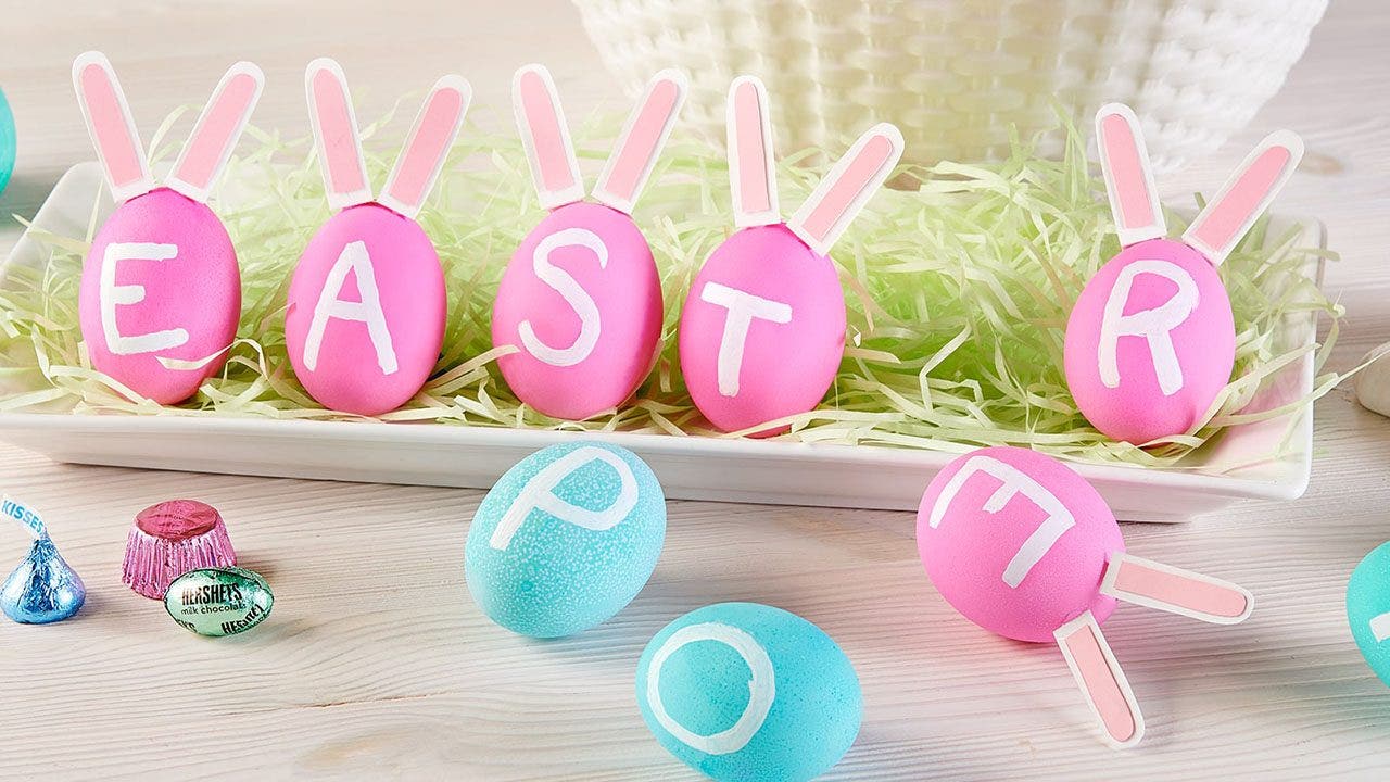 pink and blue easter eggs painted with letters