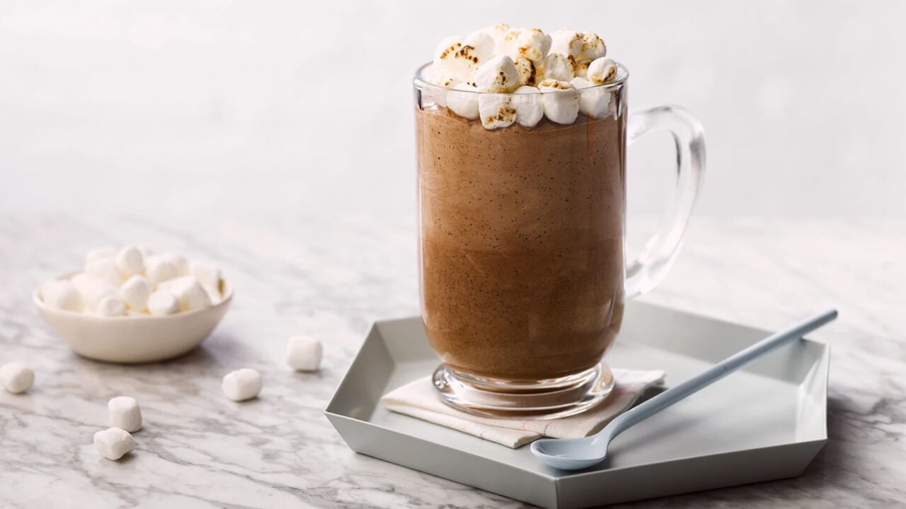 glass mug of frozen hot cocoa topped with mini marshmallows