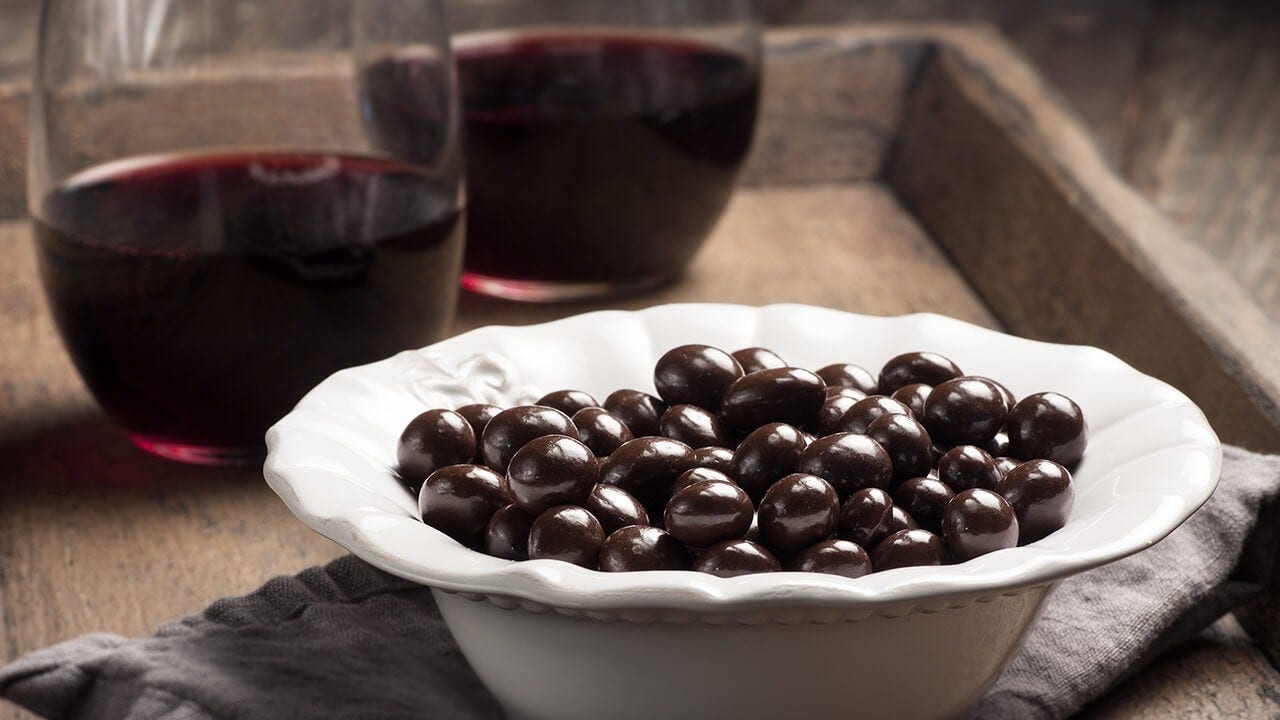 glasses of red wine on tray with brookside chocolates