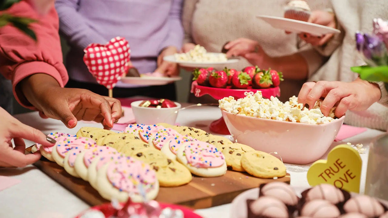 snack table with cookies, strawberries, and popcorn