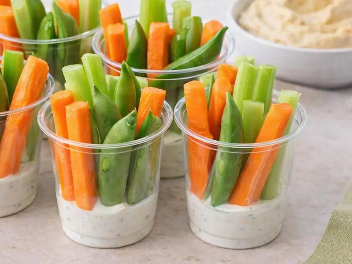 cups filled with veggies and dressing