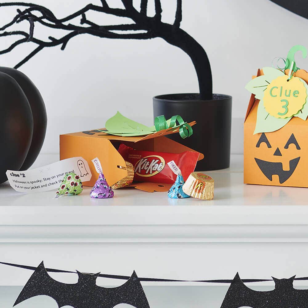 Halloween candy hidden in pumpkin themed clue boxes
