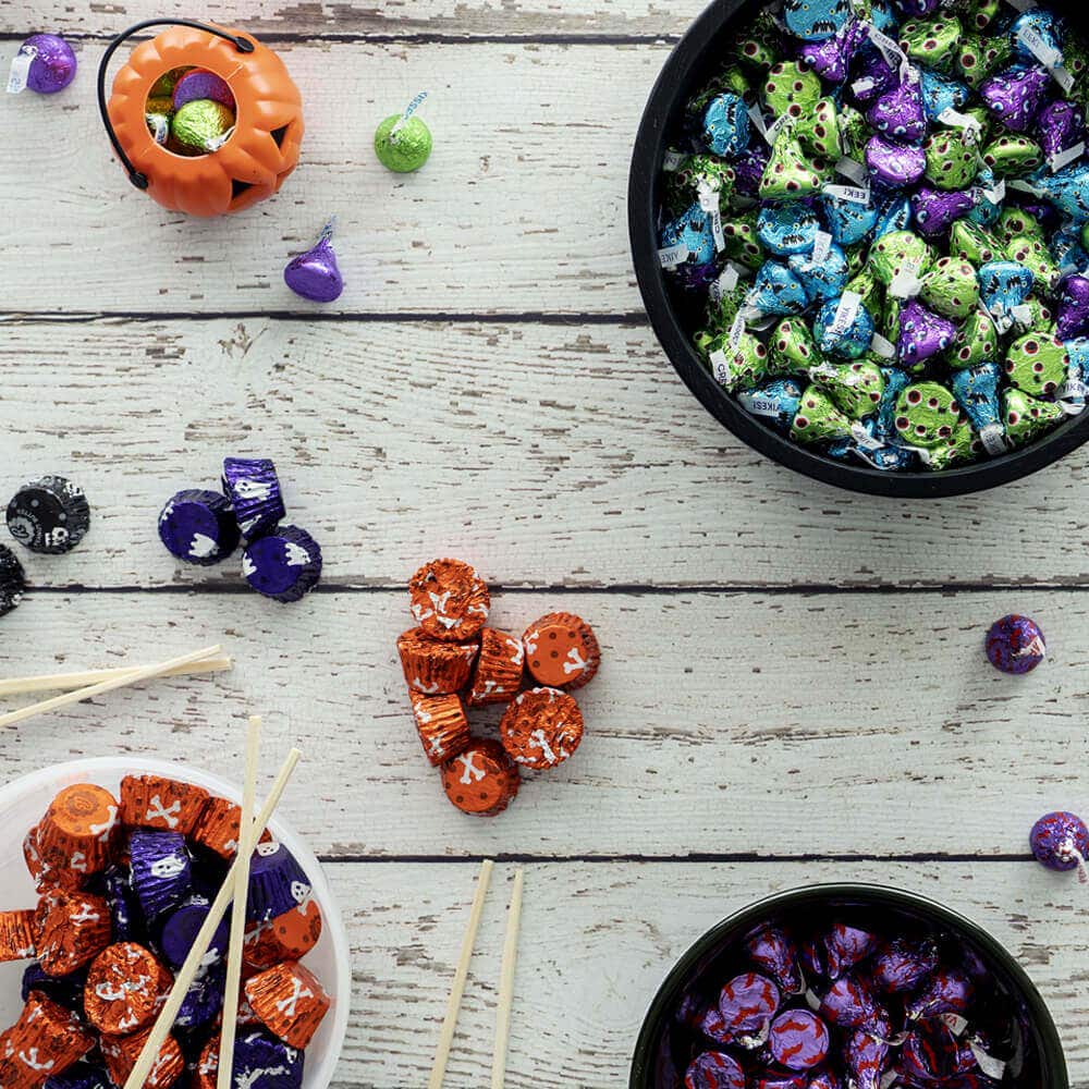 bowls of halloween candy on a table with chopsticks