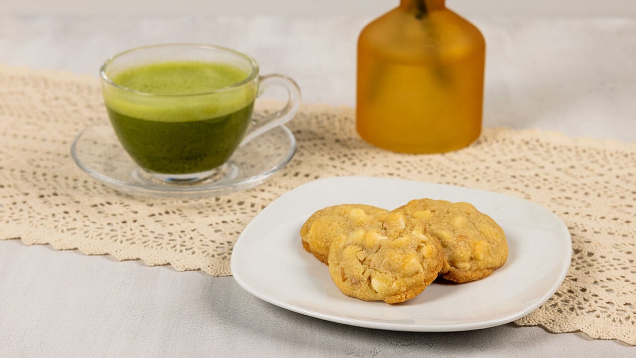 plate of hersheys premier white chips and macadamia pieces cookies paired with matcha tea