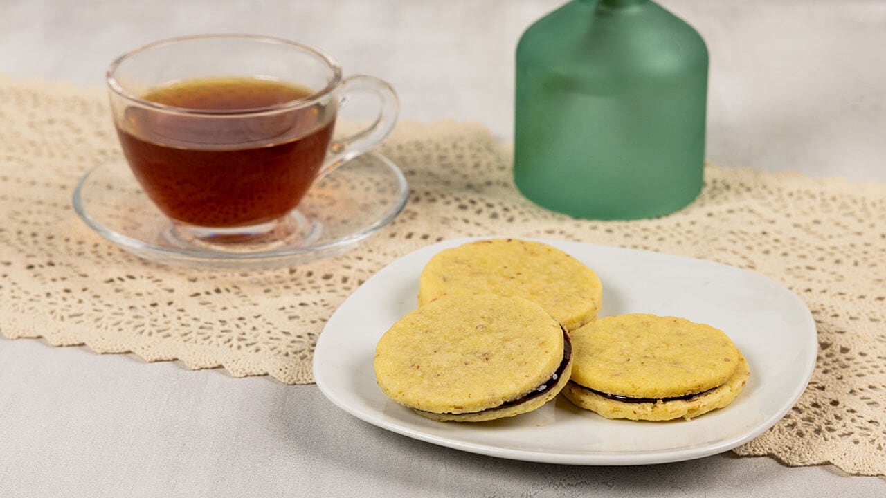 plate of almond shortbread cookies with chocolate filling paired with earl grey tea