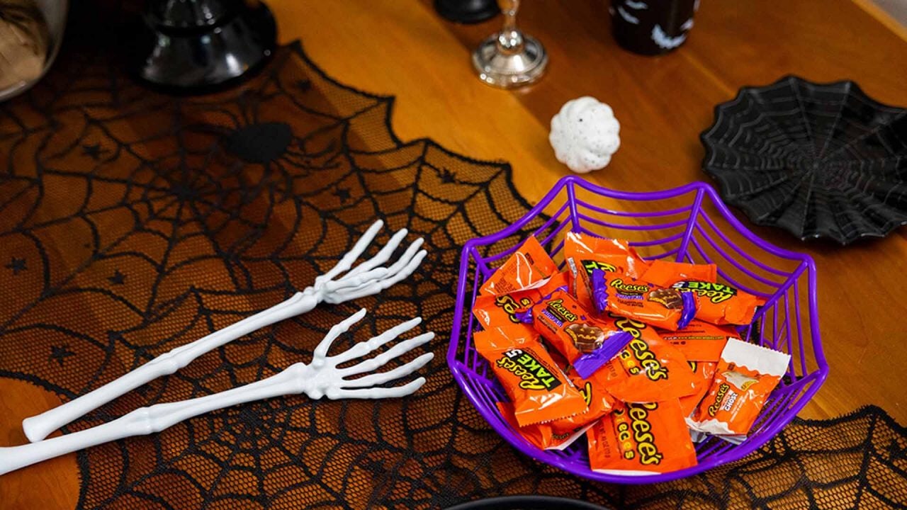 spider web themed candy dish filled with reeses candies