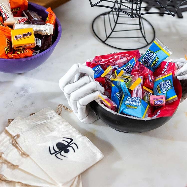 cauldron themed candy dish filled with assorted hersheys fruity candies