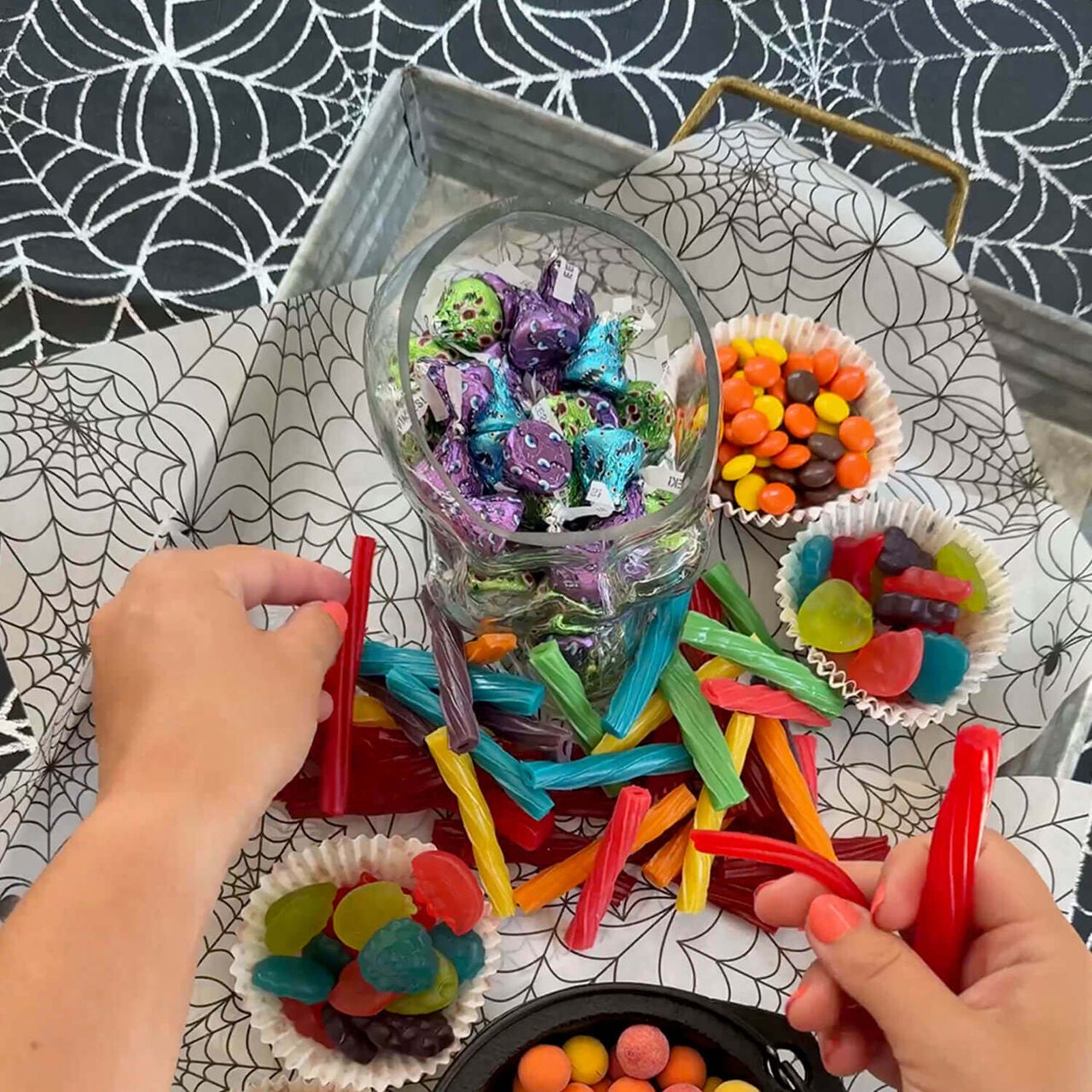 hershey candies being added to halloween themed charcuterie board