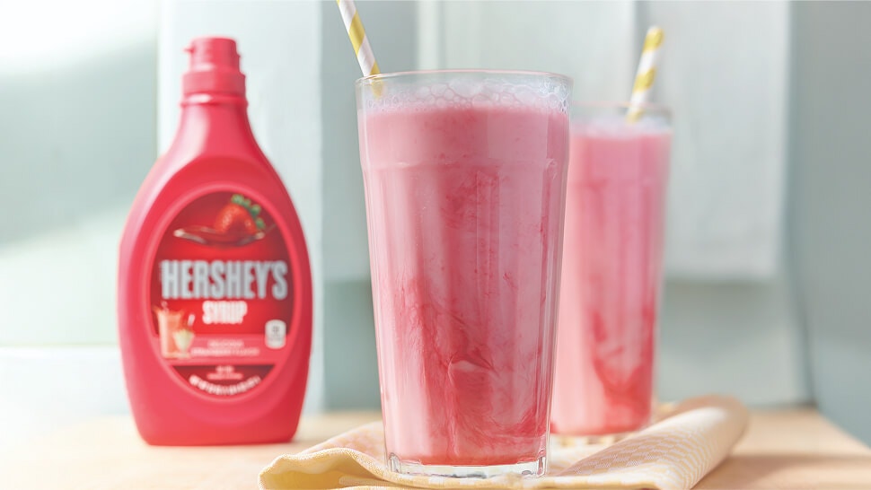hersheys strawberry syrup added to two glasses of milk