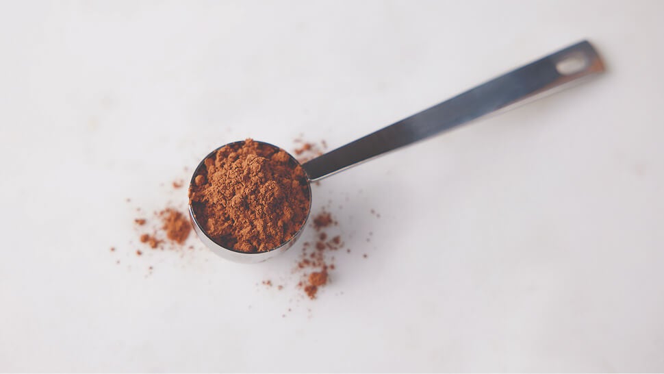 measuring spoon filled with hersheys cocoa